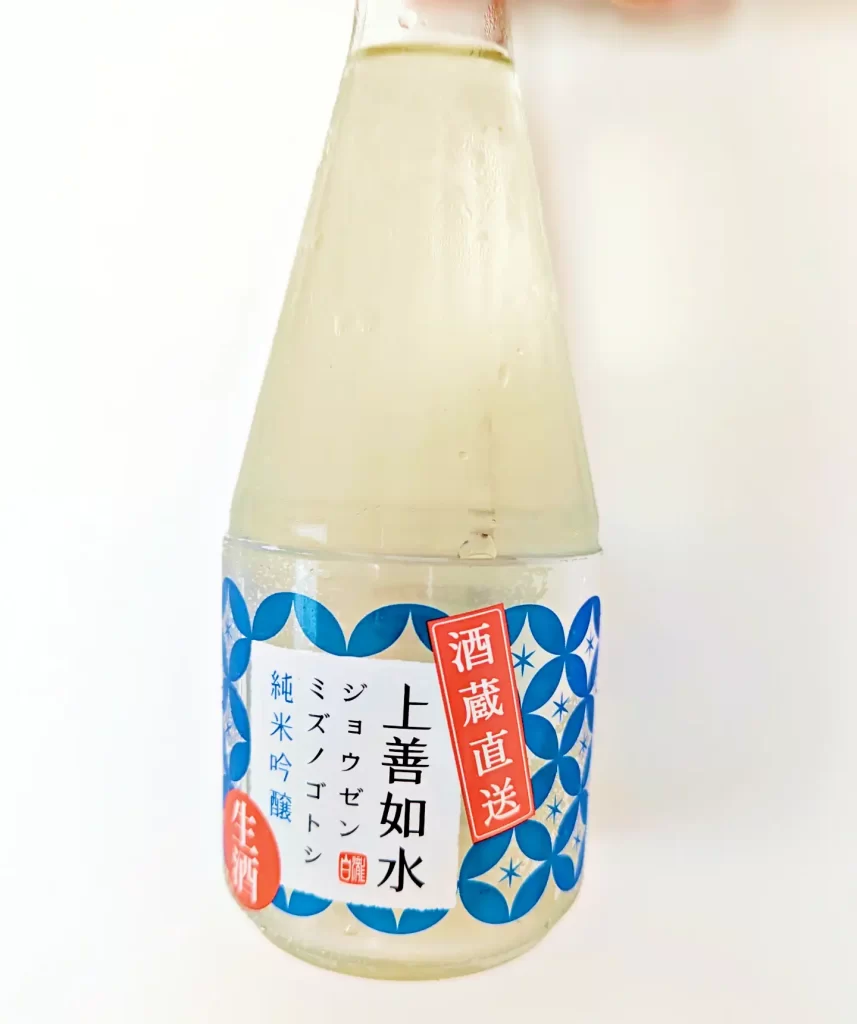 白瀧酒造の日本酒「上善如水 純米吟醸 生酒」のボトル写真。青と白を基調としたラベルデザインが特徴で、「酒蔵直送」「生酒」の表示が目を引く。冷蔵保存された300mlサイズの日本酒で、瓶には結露した水滴が見られ、フレッシュな状態が伝わる。